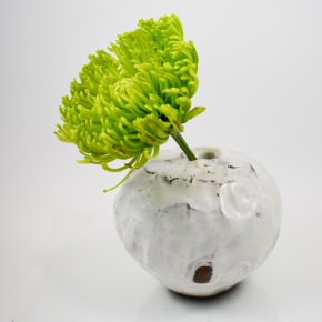 orb vase with green flower
